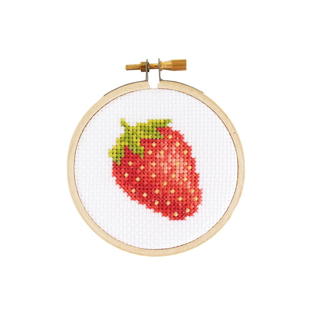 Finished strawberry cross stitch in a small wooden hoop