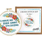 "I have no idea what I'm doing" cross stitch hoop beside The Stranded Stitch No Idea kit box