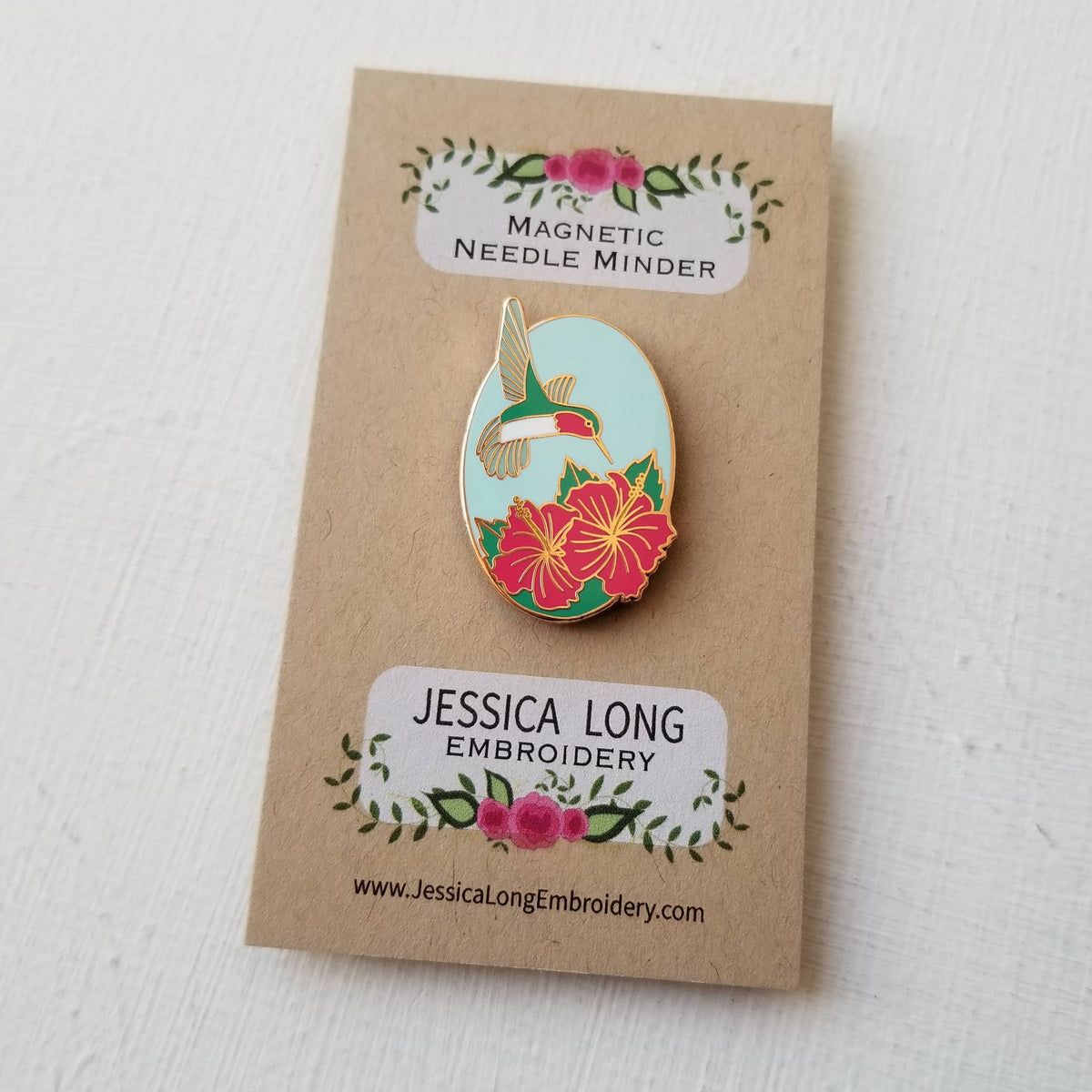 Hummingbird magnetic needle minder by Jessica Long Embroidery on its backing card