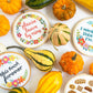 "This took forever" and other Stranded Stitch cross stitch hoops styled among autumn gourds and pumpkins