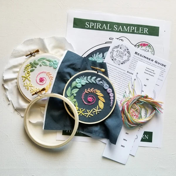 Spiral sampler embroidery kit: two stitched hoops, navy and cream fabric, floss and a beginner guide