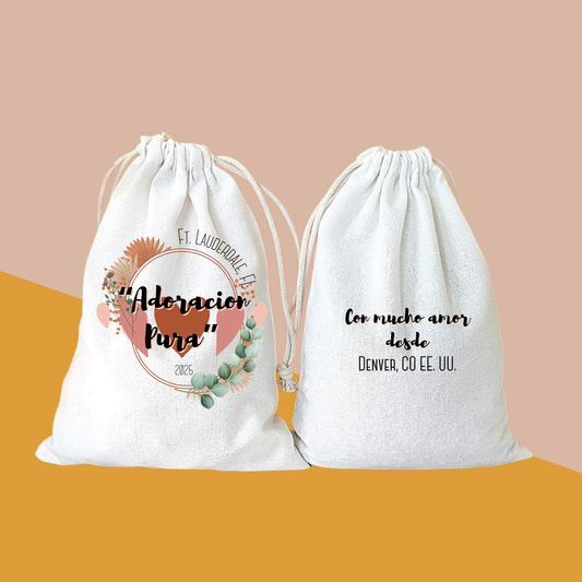 Two canvas drawstring gift bags printed "Adoración Pura" Ft. Lauderdale, FL 2025 and "Con mucho amor desde Denver, CO EE. UU."