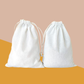 Two plain natural canvas drawstring gift bags