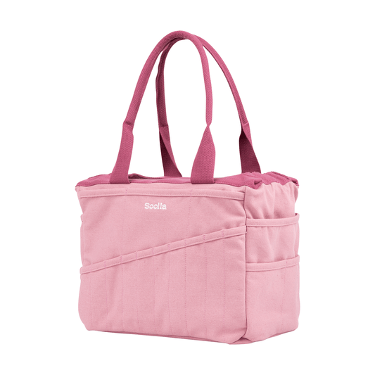 Angled view of the dusty pink Soolla craft bag with raspberry handles