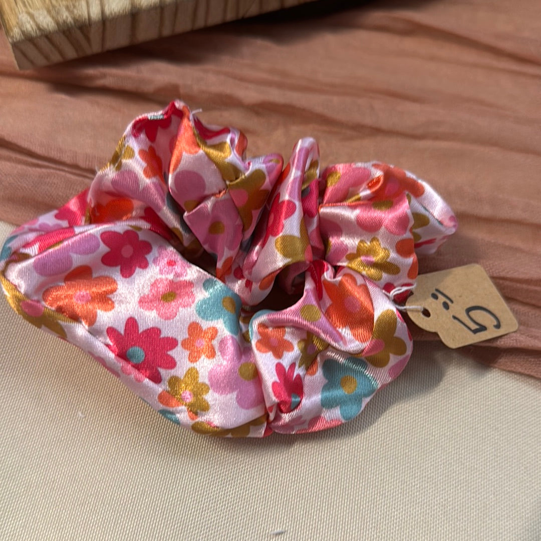 Pink satin scrunchie with a retro orange, pink and gold flower print and a $5 price tag