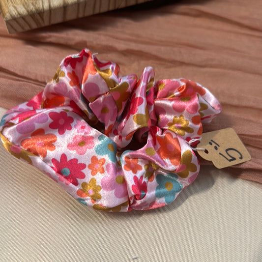 Pink satin scrunchie with a retro orange, pink and gold flower print and a $5 price tag