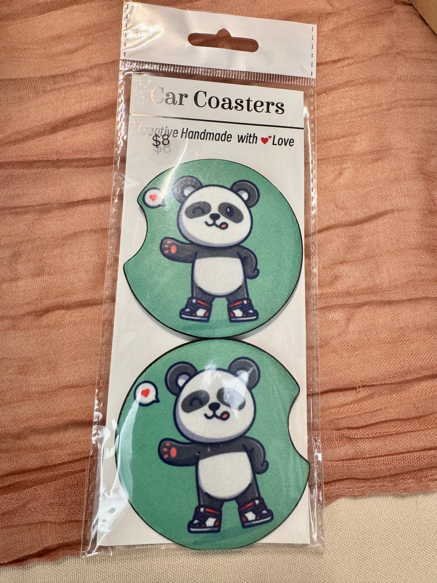 Pair of green car coasters with a waving cartoon panda in sneakers