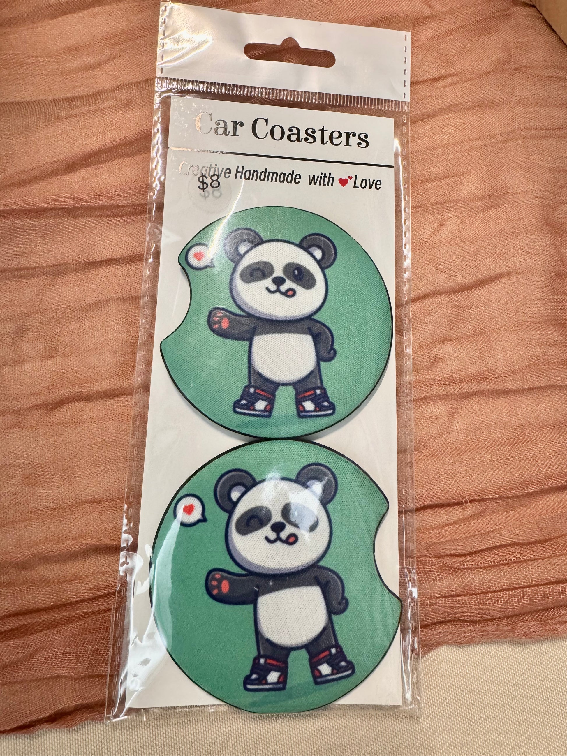 Pair of green car coasters with a waving cartoon panda in sneakers