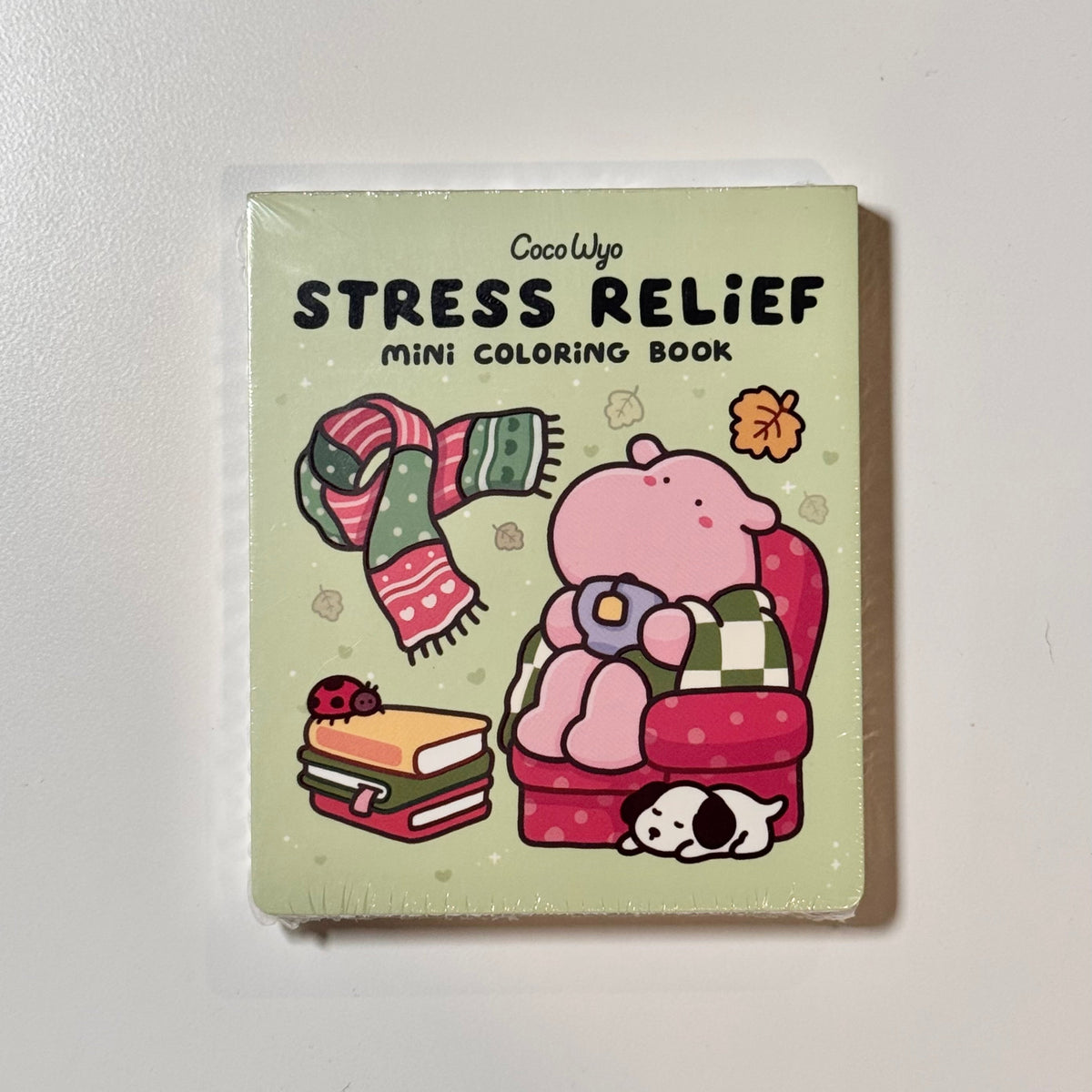 Stress Relief mini coloring book by Coco Wyo: a pink bear in an armchair with a scarf, books and a puppy