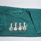Teal "just a crafty goose" T-shirt laid flat