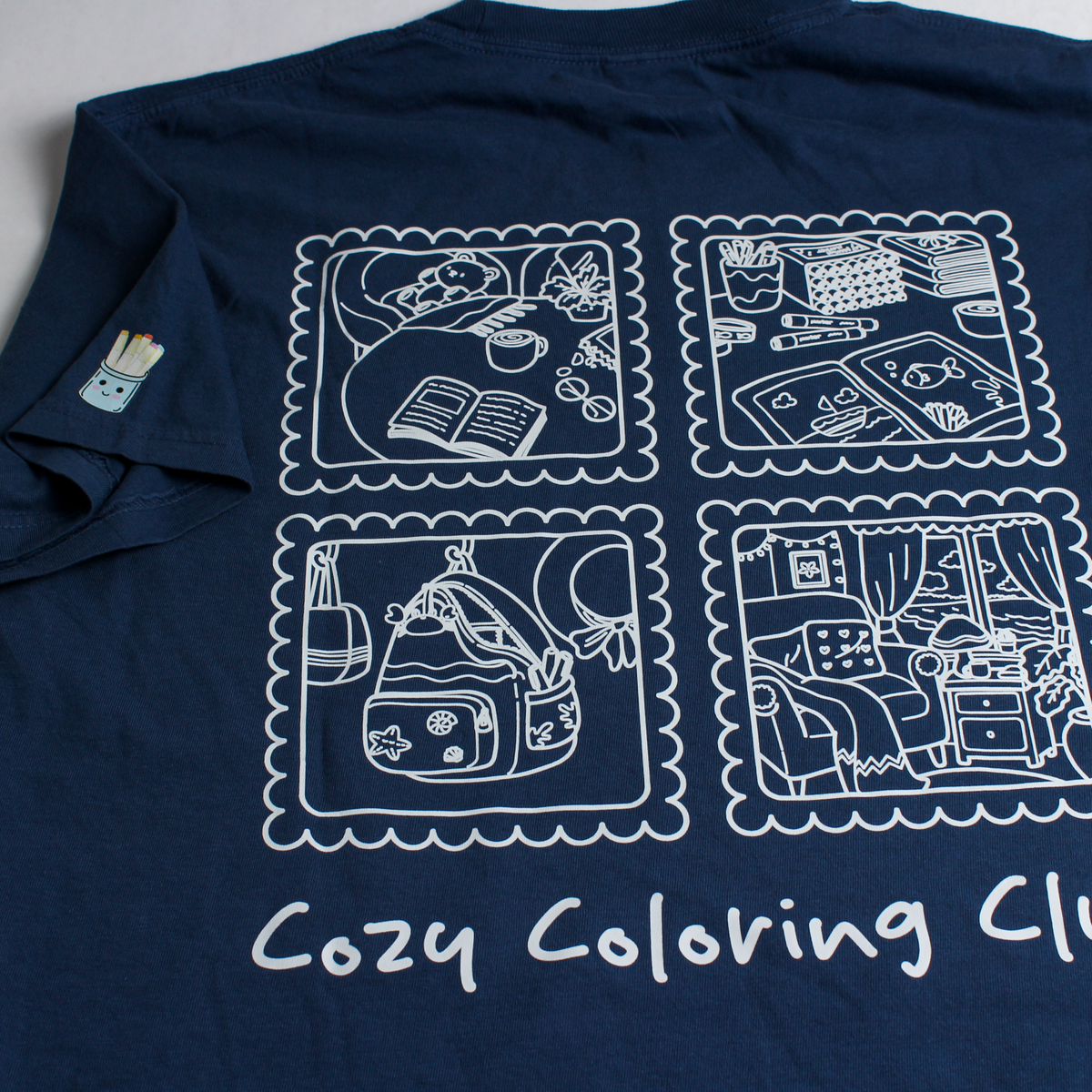 Dark blue Cozy Coloring T-Shirt with kawaii coloring book graphic, back view