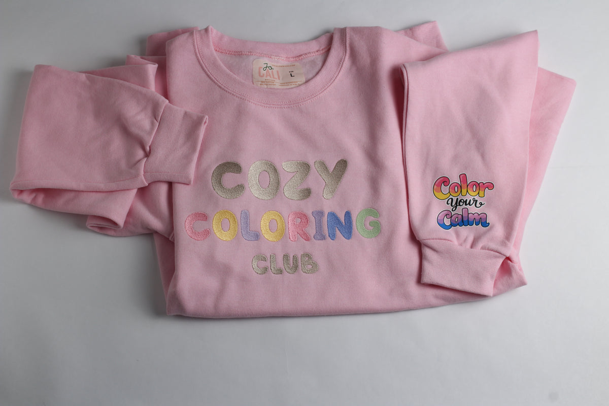 Pink Cozy Coloring Club crewneck with a Color your Calm design on the sleeve