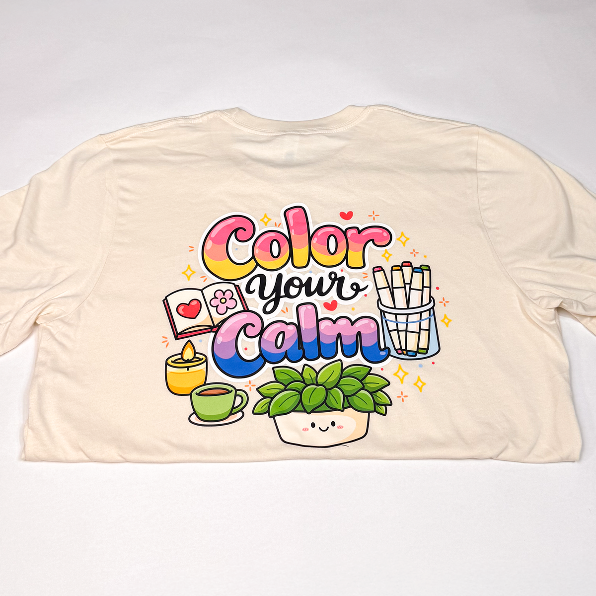 Cream T-shirt laid flat showing the Color your Calm back print