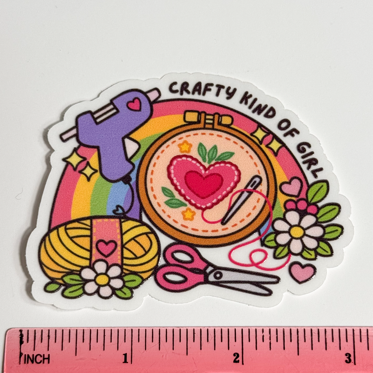 "Crafty kind of girl" sticker next to a ruler, about 3 inches wide