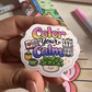 Hand holding the "Color your Calm" sticker over a coloring page and markers