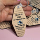 Hand holding a tan motel-style keychain reading "June 9-14 2025, An Unforgettable Week, Panama City, FL, Best Life Ever"