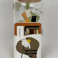 Phone card wallet with a white daisy on a taupe shape and the Salmos 56:3 quote, attached to a glass cup