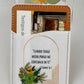 Phone card wallet with a green floral arch and the Salmos 56:3 quote, holding a card