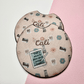 Pair of pink car coasters personalized with the name Cali and small illustrated icons