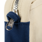 Close-up of the YKK zipper pull on the navy and cream Soolla pouch