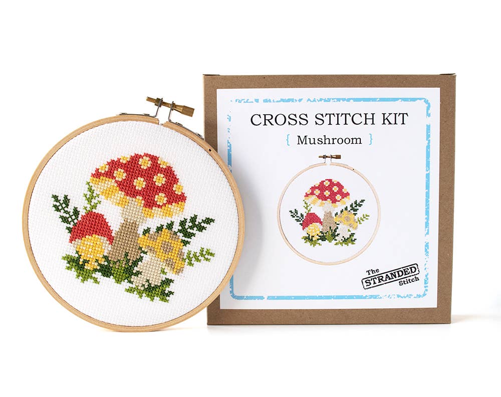 Mushroom cross stitch hoop beside The Stranded Stitch kit box