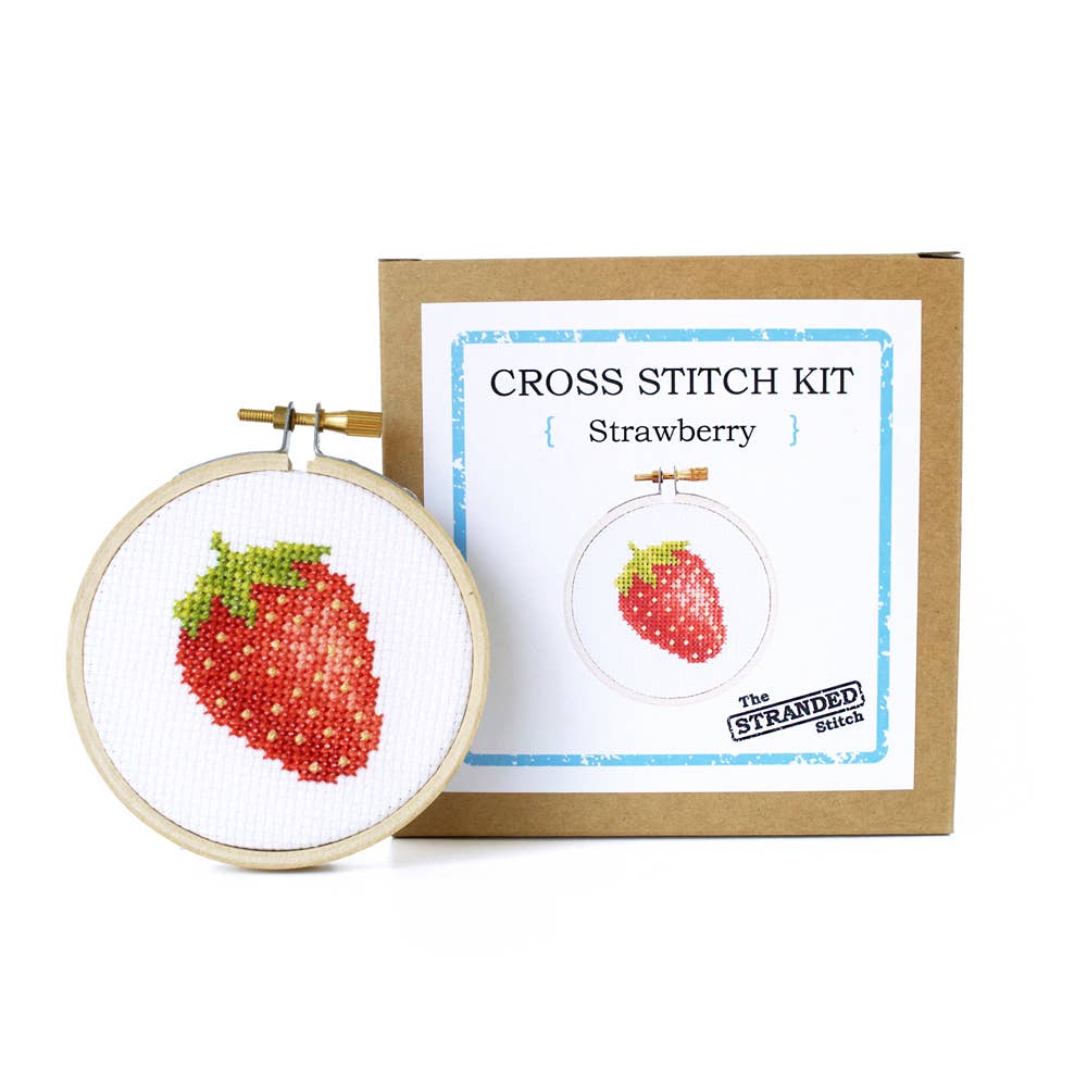 Strawberry cross stitch hoop beside The Stranded Stitch kit box