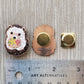 Front and back of the hedgehog needle minder and its magnet, shown against a ruler for size