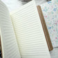 Open lined journal insert beside a pastel floral cover